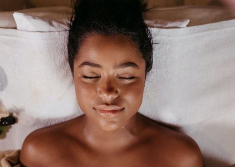 Woman relaxing with eyes closed during a customized facial treatment